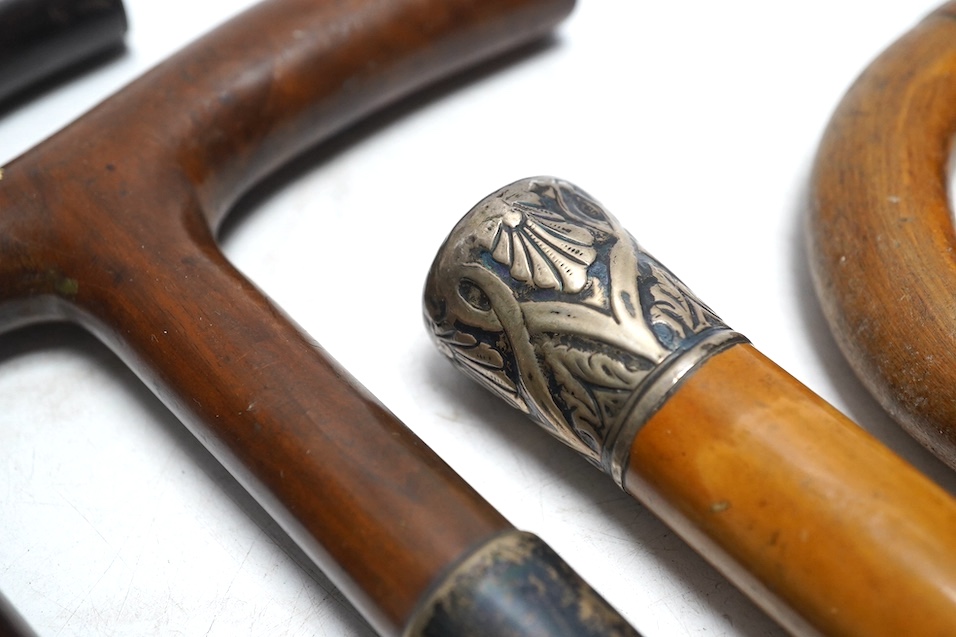 Four mixed silver mounted walking sticks, a riding crop and a baton, longest 88cm. (6). Condition - fair considering use and age